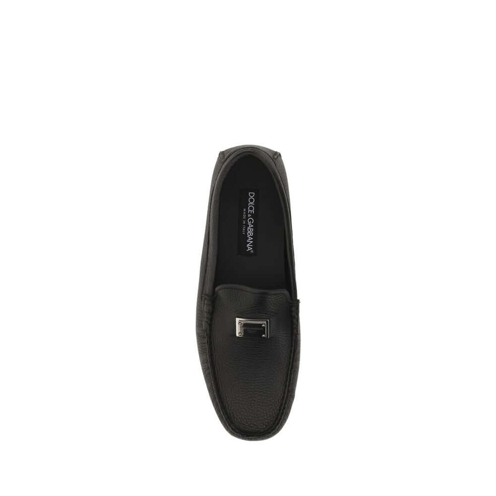 Top view of Dolce & Gabbana Black Rubber Slip-On Loafers with metal monogram, non-slip sole, made from calf leather and rubber.