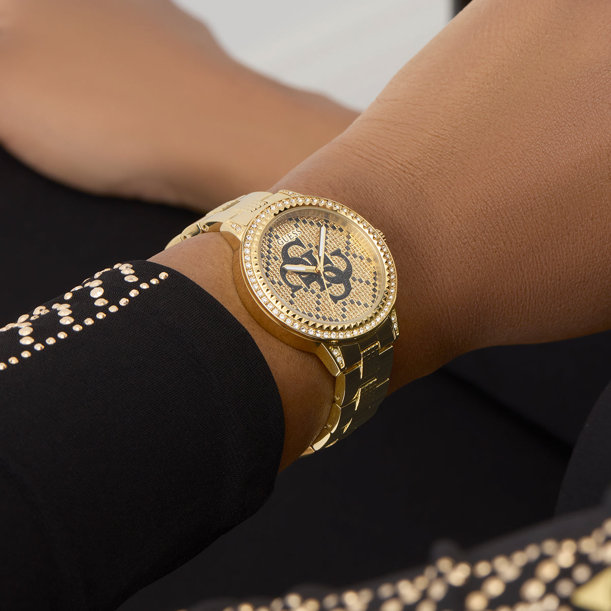 GUESS Mod. G LACE gold watch worn on wrist, showcasing stylish design and elegance.