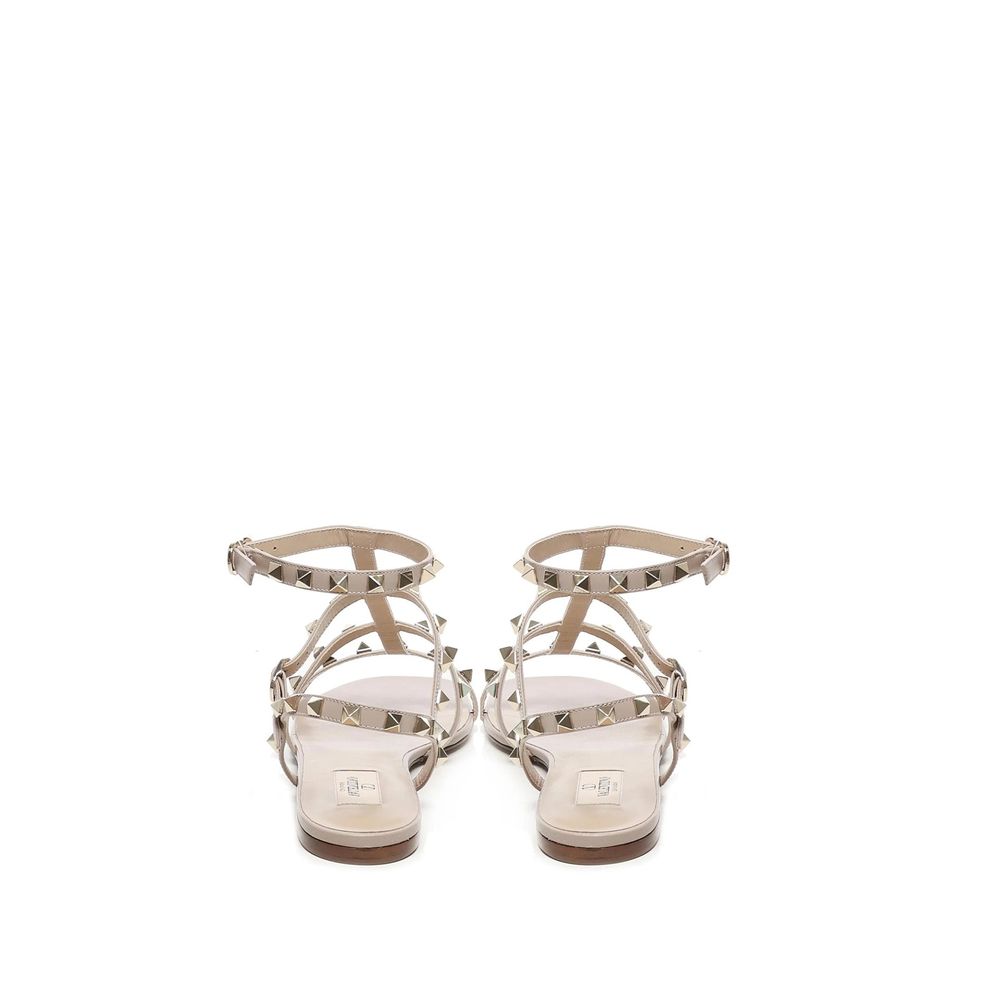 Back view of Valentino Garavani Beige Calfskin Sandals with gold-tone rockstud embellishments and ankle buckle fastening.