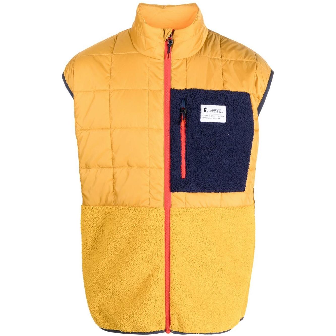 Mustard yellow COTOPAXI padded vest with chest logo patch, front zip, and zip pockets, ideal for outdoor activities and stylish layering.