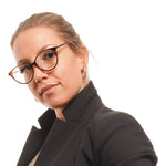 Woman wearing Max & Co Brown Women Glasses Frame in cat eye style with metal and plastic brown full-rim frame.