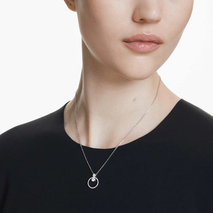 Woman wearing SWAROVSKI Mod. 5692261 silver necklace with circular pendant displayed in official box.