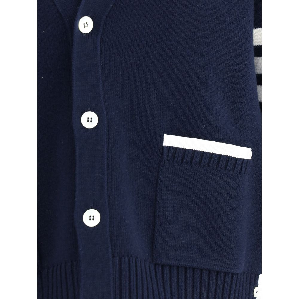 Close-up of Thom Browne Blue Merino Wool Cardigan with button details and patch pocket with contrasting piping.