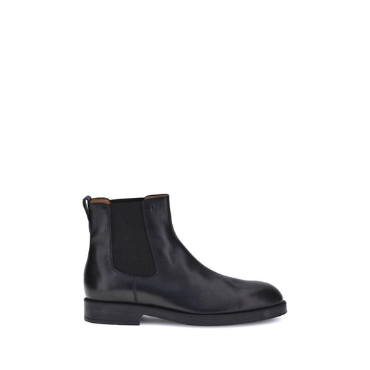 Side view of Tod's Black Calf Leather Bos Taurus Chelsea Boots with elastic side inserts and back tab for comfort, showcasing elegant design.