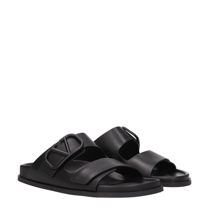 Valentino Garavani Black Leather Slippers with front logo, flat low heel, open toe, rubber sole, suitable for casual wear.