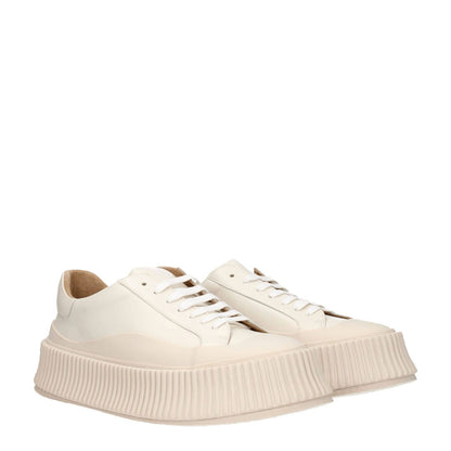 Jil Sander Beige Leather Platform Sneakers with aged effect, lace-up closure, rubber sole, and 5 cm wedge heel.