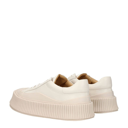 Jil Sander Beige Leather Platform Sneakers with aged effect and wedge heel, featuring a lace-up closure and rubber sole.