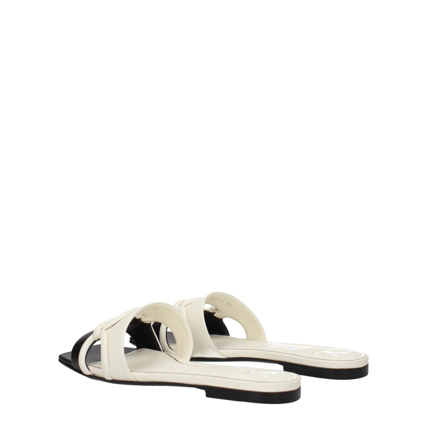 Valentino Garavani Black Leather Slippers with ivory accents, open toe, low flat heel, crafted from premium leather. Casual style footwear.