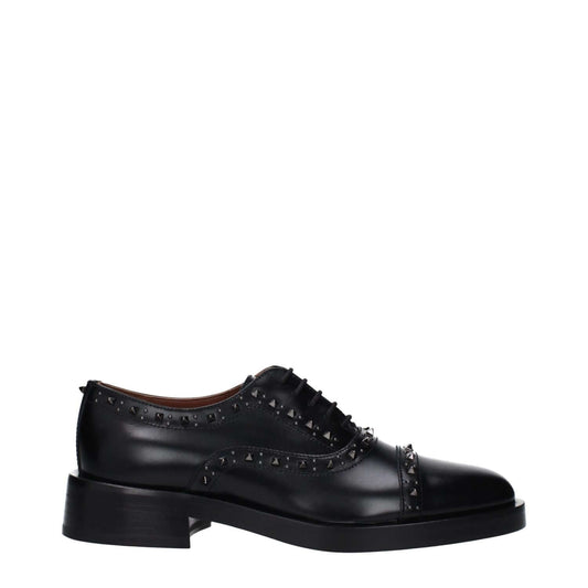 Valentino Garavani Black Leather Oxfords And Derbies with studs, round toe, lace-up closure, and mid heels.