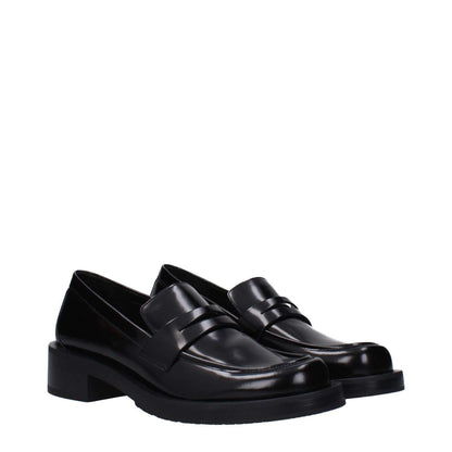 Stuart Weitzman Black Leather Slip-On Loafers with mid heels and round toe, made of leather and rubber sole.
