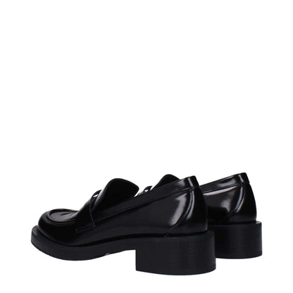Stuart Weitzman Black Leather Slip-On Loafers with rubber sole and round toe, side view showing mid heel design.