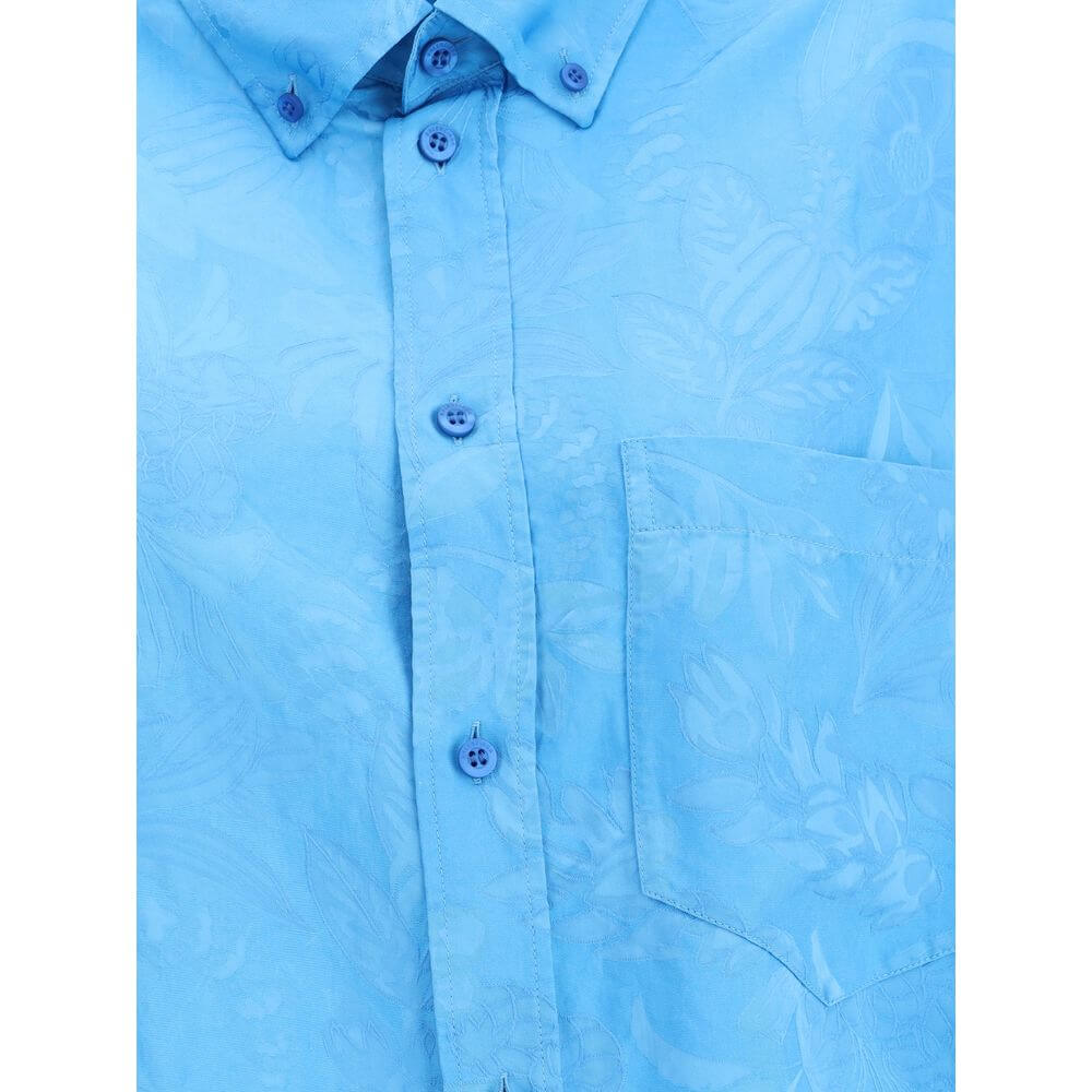 Close-up of Balenciaga Blue Viscose Pattern Shirt featuring floral design, button-down front, and chest pocket for a contemporary look.
