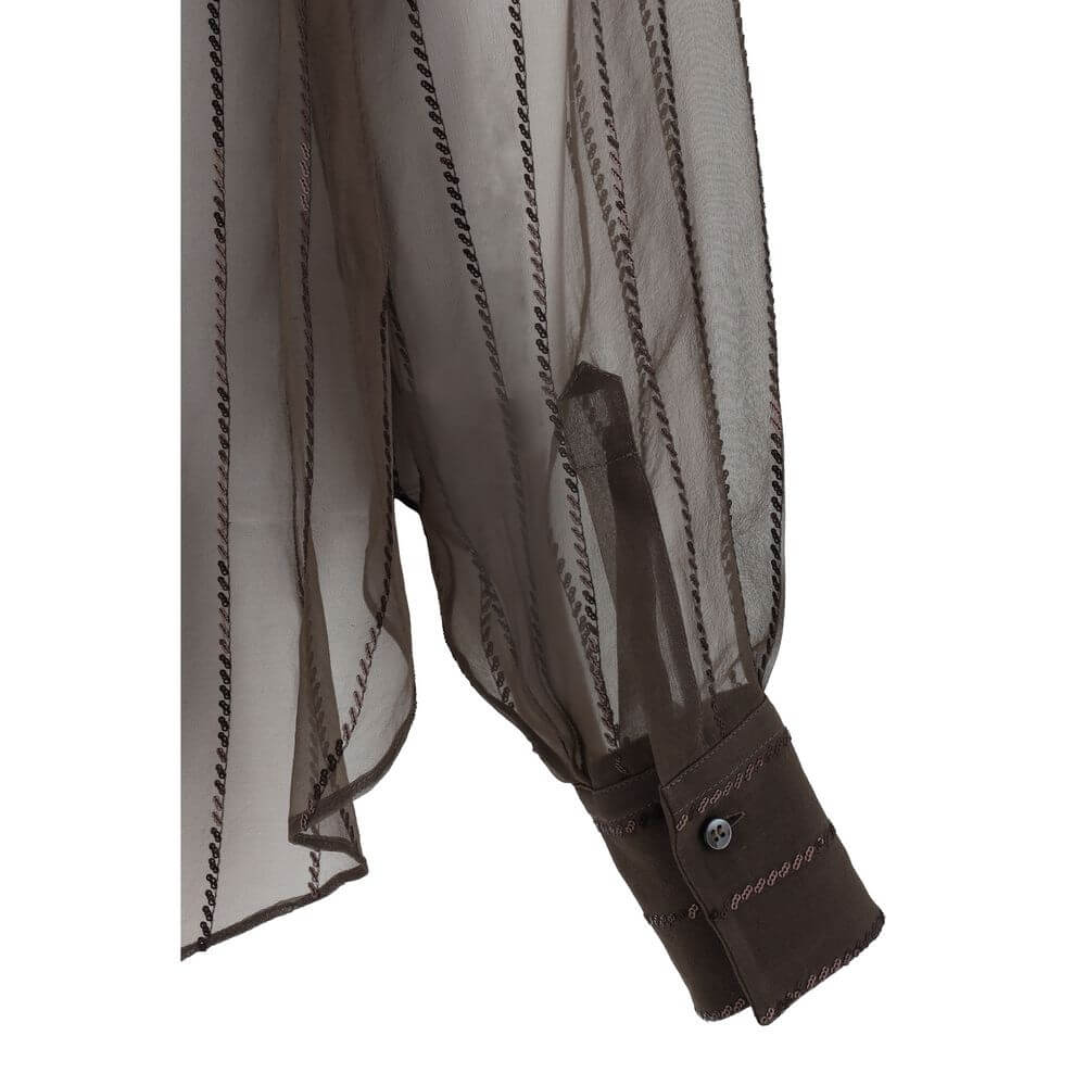 Elegant sleeve detail of Brunello Cucinelli Brown Silk Blouse with semi-transparent design and adjustable button cuff, featuring sequins.