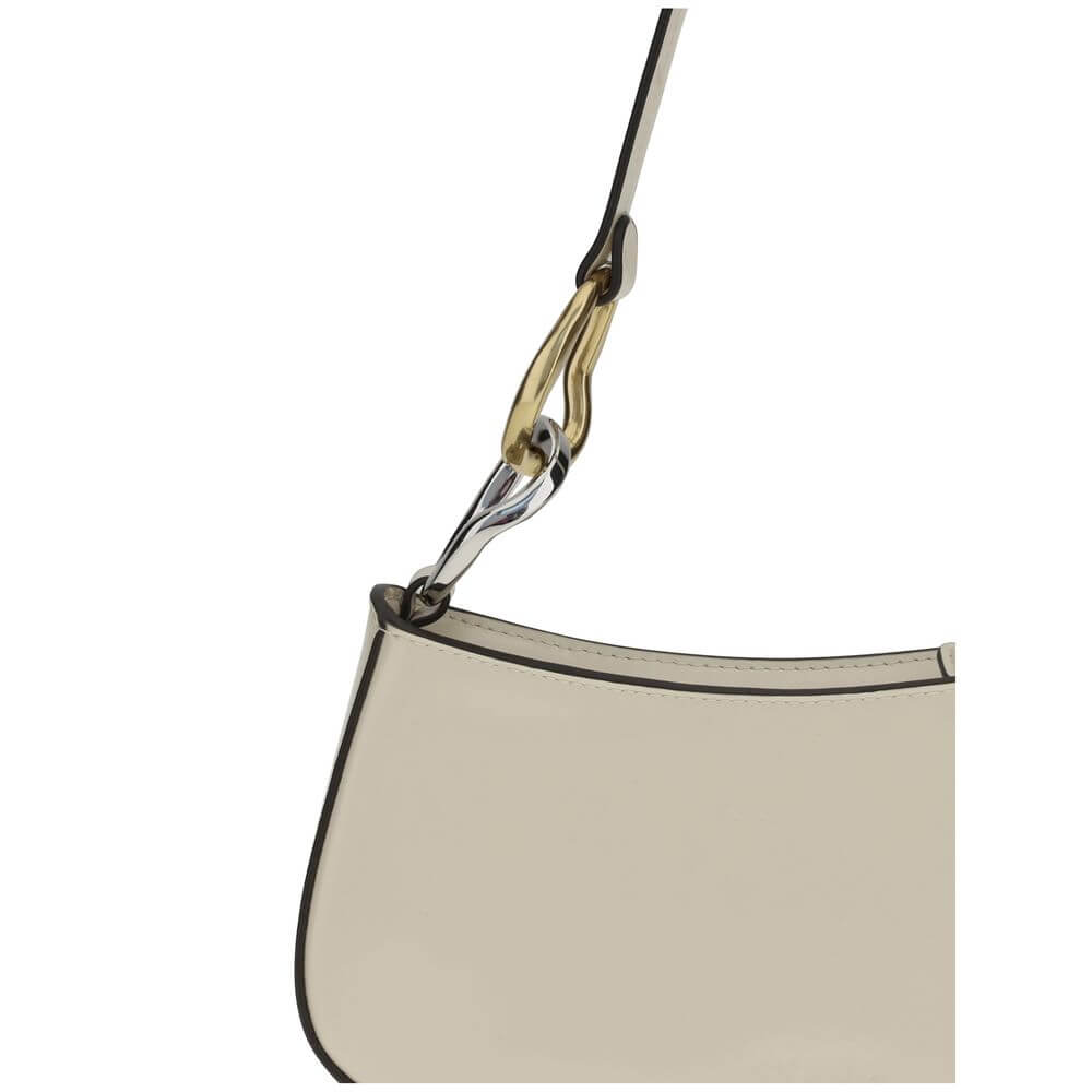 Close-up of Staud Cream Calf Leather Bos Taurus Shoulder Bag with double snap hook detail on strap.