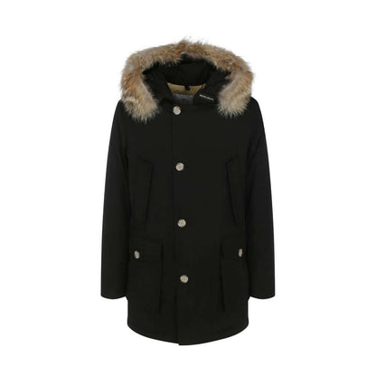 Woolrich Black Cotton Parka with fur hood, oversized fit, and front pockets, perfect for AW25 season. Made in Bulgaria. 60% Cotton, 40% Polyamide.