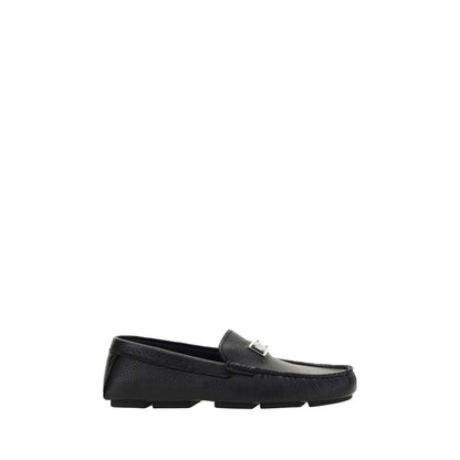 Dolce & Gabbana Black Rubber Slip-On Loafers with calfskin upper and metal monogram plaque on a non-slip sole.