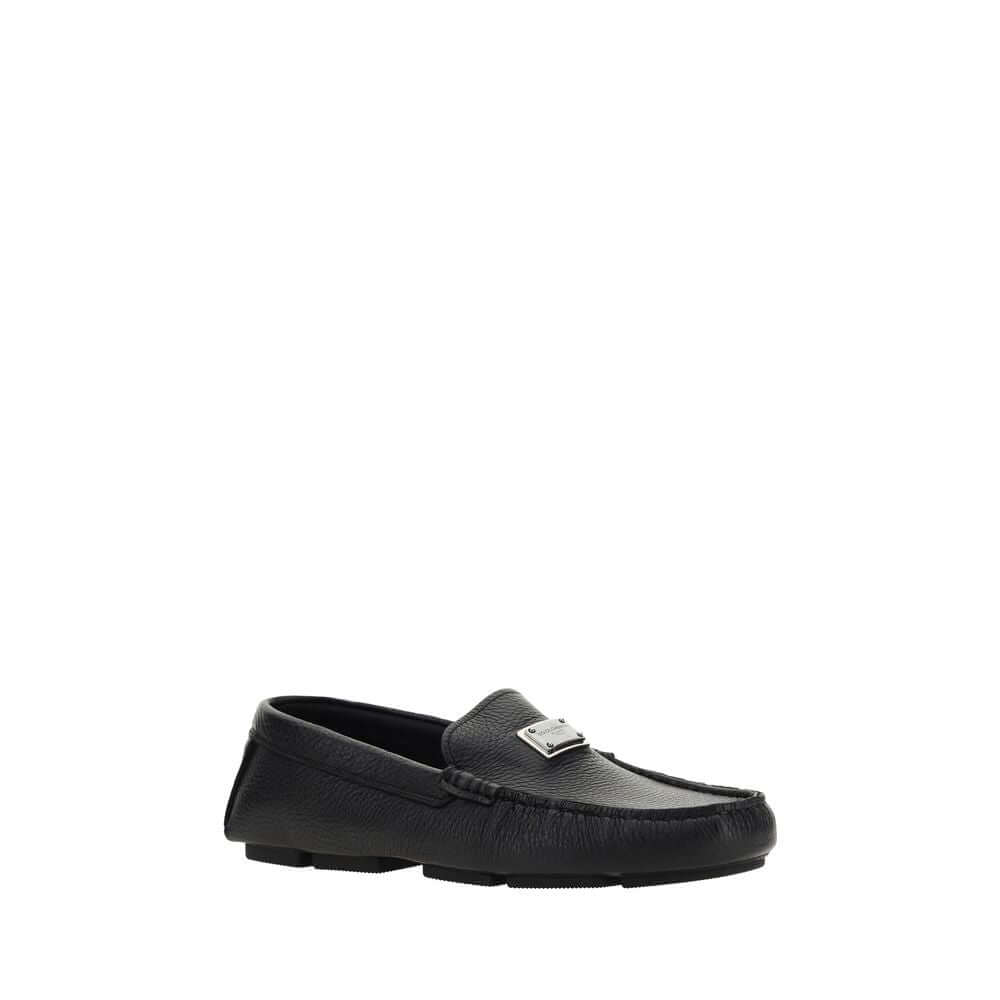 Dolce & Gabbana Black Rubber Slip-On Loafers with calfskin upper, featuring iconic metal monogram plaque, flat non-slip sole, made in Italy.