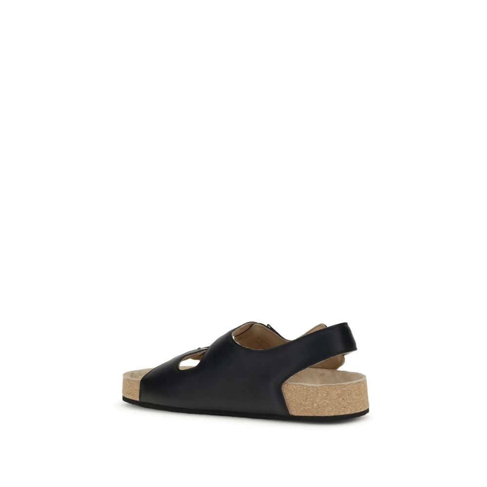 Balenciaga Black Calf Leather Bos Taurus Flat Sandals with ergonomic insole and cork-lined sole, side view.
