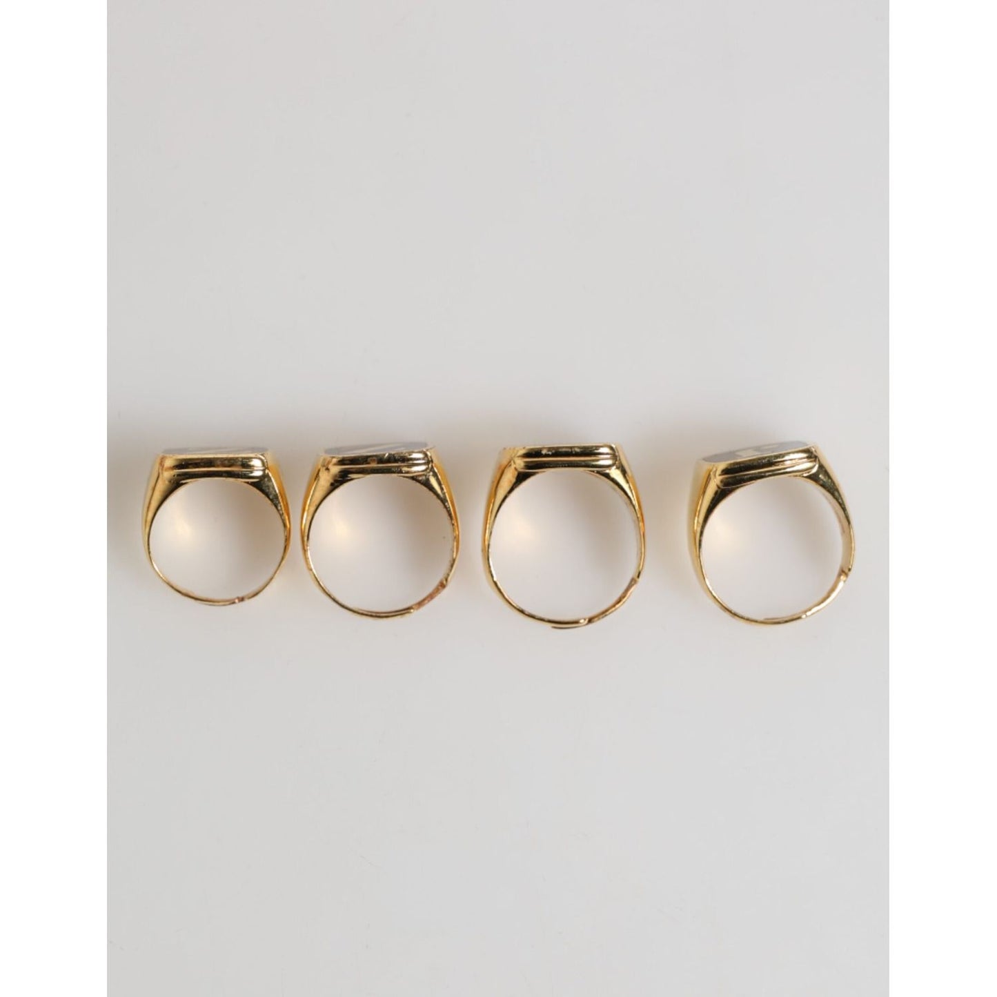 Dolce & Gabbana Gold Tone Brass JAZZ Letter Set 4 Pieces Adjustable Ring displayed on a white background.