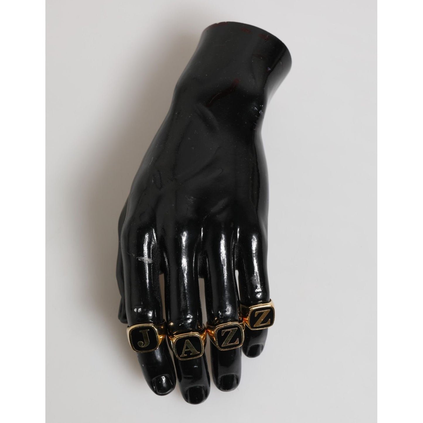 Dolce & Gabbana Gold Tone Brass JAZZ Letter Set 4 Pieces Adjustable Ring on black mannequin hand