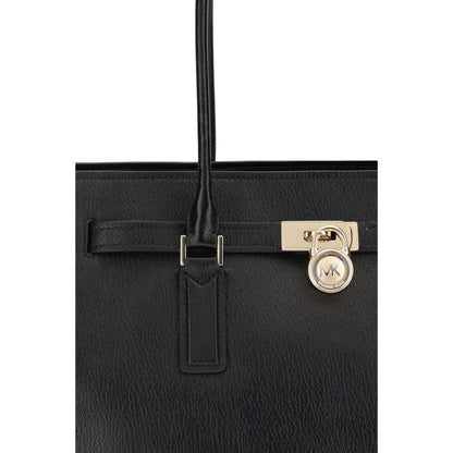 Close-up of Michael Kors Black Calf Leather Bos Taurus Shoulder Bag with decorative belt and iconic padlock.