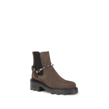 Valentino Garavani Brown Calf Leather Bos Taurus Chelsea Boots with studs and buckle, side view showing lug sole and suede texture