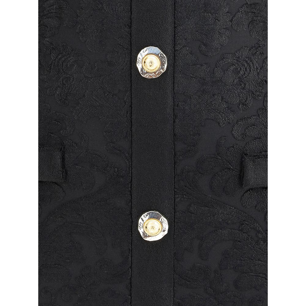 Close-up of Balmain Black Viscose Cocktail Dress showing gold embossed buttons and baroque pattern.