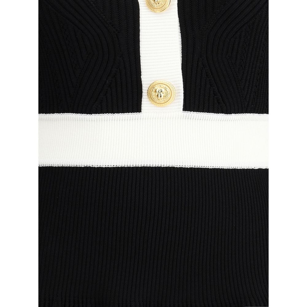 Close-up of Balmain Black Viscose Casual Dress with embossed buttons and ribbed knit detailing.