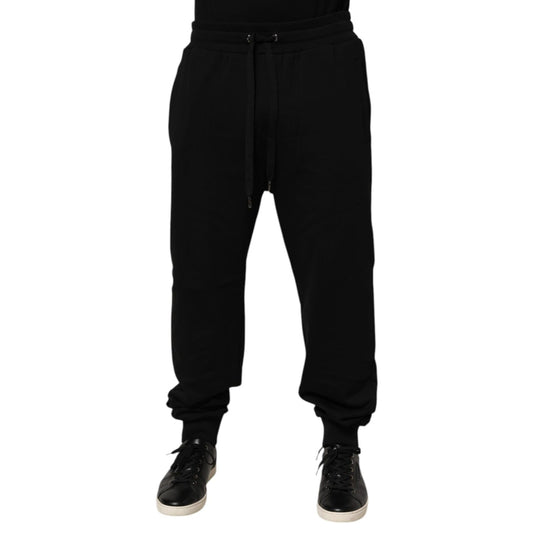Dolce & Gabbana Black Cotton Drawstring Logo Sweatpants Pants with ribbed hems and logo patch, perfect for luxury casualwear.