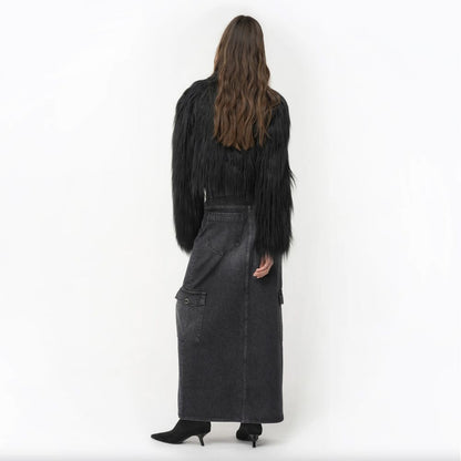 Back view of model wearing PINKO Black Cotton Skirt with long hem, zip closure, and multiple pockets.