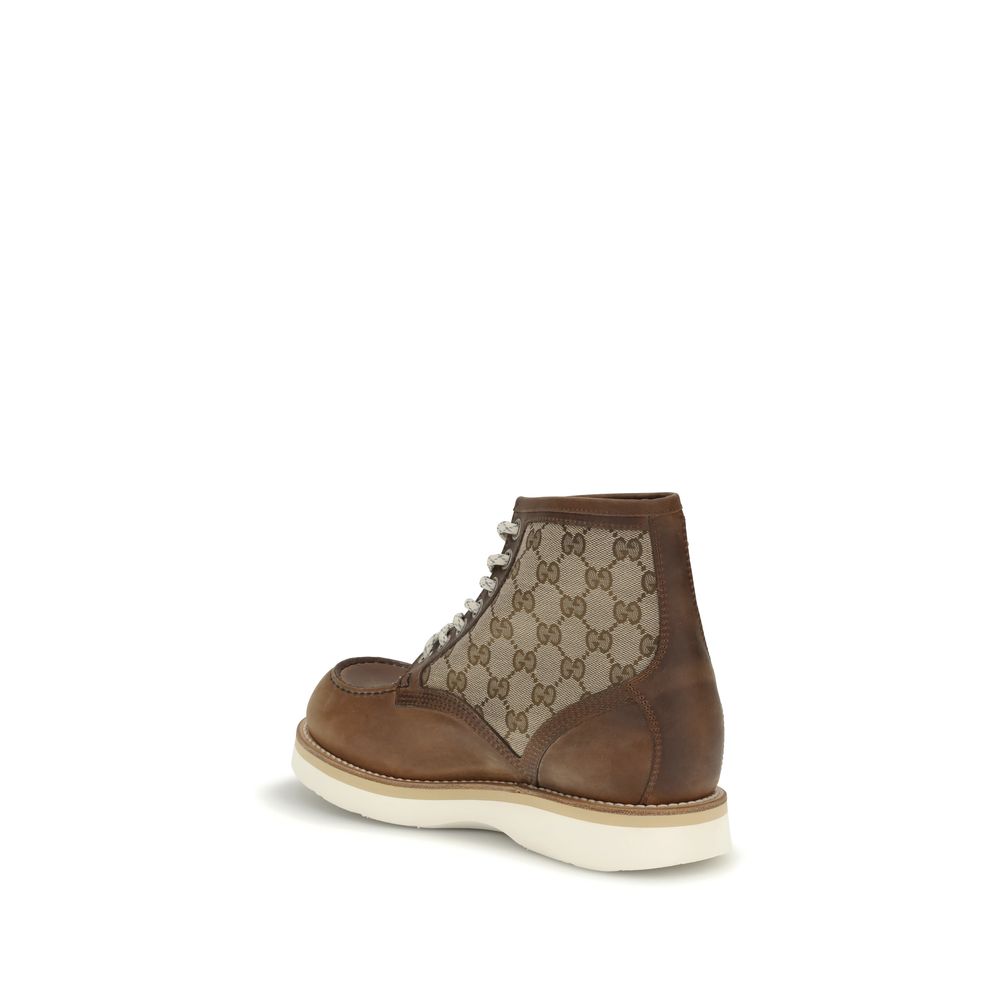Gucci Brown Leather Lace-Up Boots with GG fabric insert showcasing traditional design and Goodyear construction on white rubber sole.
