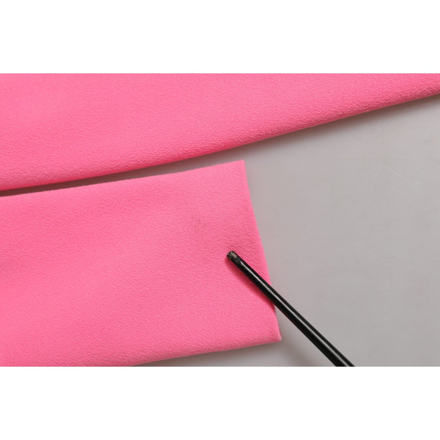 Close-up of Dolce & Gabbana Pink Polyester Long Sleeves Sheath Midi Dress fabric with a pointer highlighting its texture.