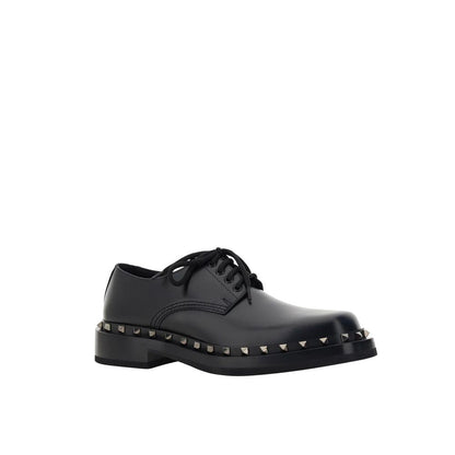 Valentino Garavani Black Calfskin Oxfords And Derbies with studs detail, round toe, front lace-up closure, made in Italy.