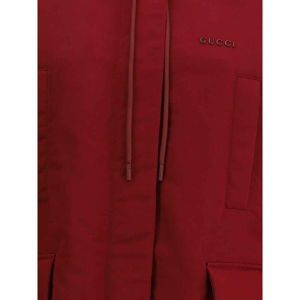 Close-up of Gucci Bordeaux Polyester Shell Jacket showing the red fabric and logo detailing.