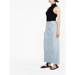 Model wearing AGOLDE PRE Skirts Clear Blue, a light blue, mid-rise, organic cotton denim maxi skirt with a frayed edge and five pockets.