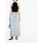 Model wearing AGOLDE PRE Skirts Clear Blue maxi denim skirt with light blue organic cotton and frayed edge detail.