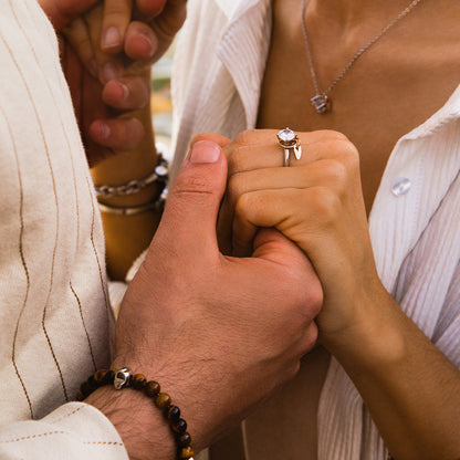 Couple holding hands with engagement ring, wearing AN JEWELS JEWELRY Mod. AL.NLFY01 necklace