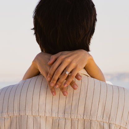 Couple embracing with a focus on a diamond ring, showcasing AN JEWELS JEWELRY Mod. AL.RLFY01-8 against a serene backdrop.