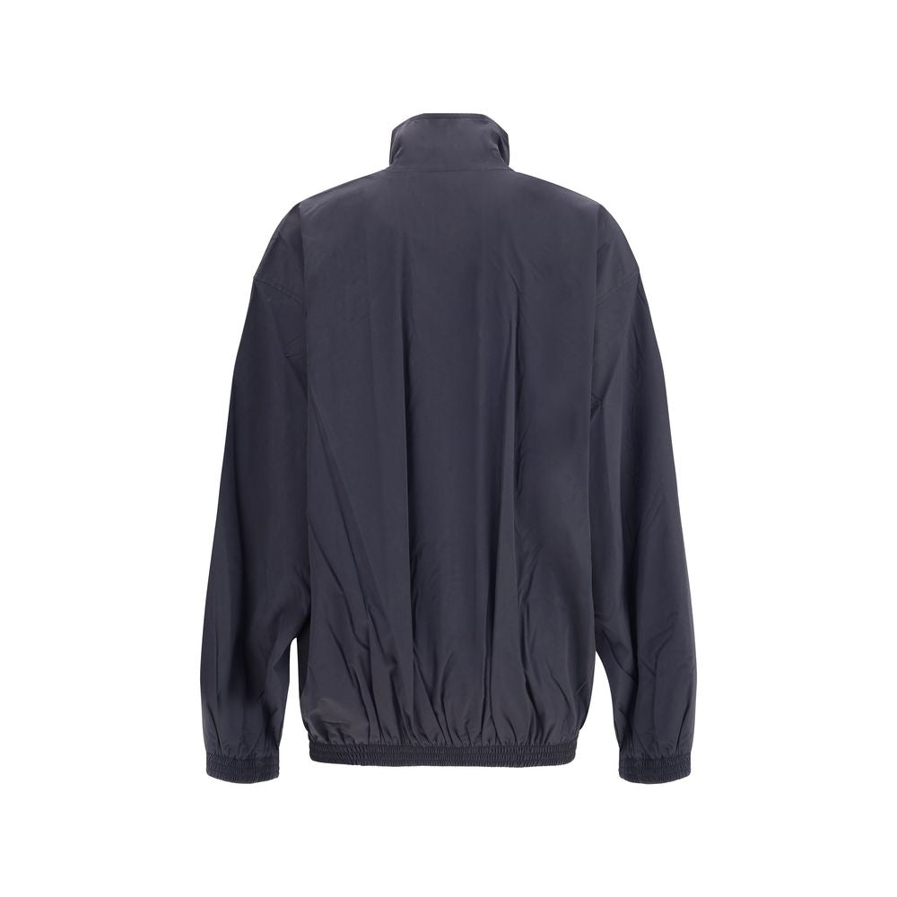 Rear view of Balenciaga Blue Polyester Clothing waterproof jacket with high collar and elastic hem, showcasing urban style and functionality.