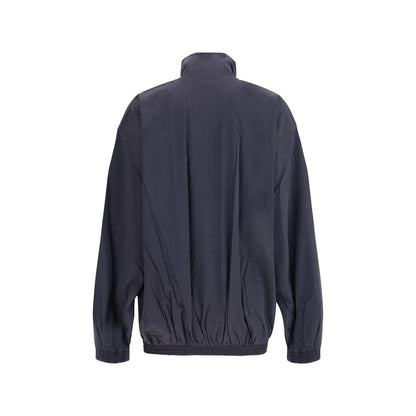 Rear view of Balenciaga Blue Polyester Clothing waterproof jacket with high collar and elastic hem, showcasing urban style and functionality.