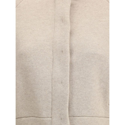 Close-up of Brunello Cucinelli Beige Cashmere Clothing featuring button and zipper closure and modern style.