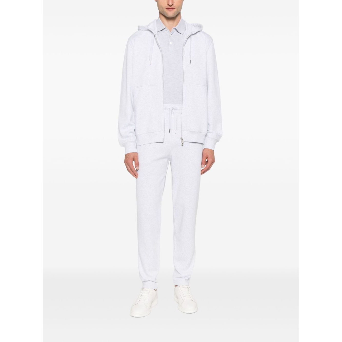 Model wearing Brunello Cucinelli Cotton track pants in light grey with elasticated drawstring waistband and side slit pockets.