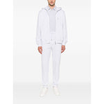 Model wearing Brunello Cucinelli Cotton track pants in light grey with elasticated drawstring waistband and side slit pockets.