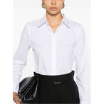 Brunello Cucinelli Shirts White with pointed collar and Monili chain, shown on model with black pants and clutch