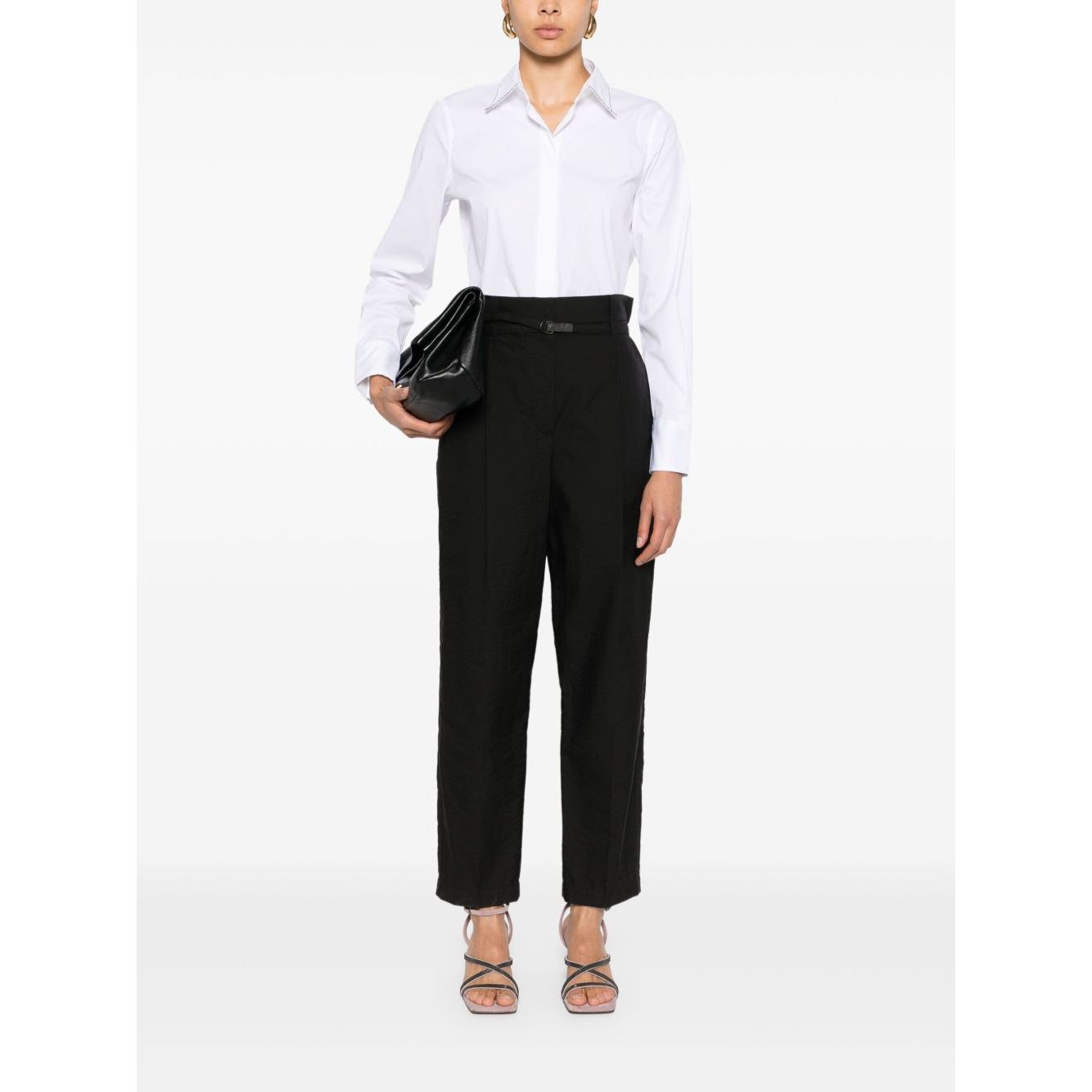 Woman wearing Brunello Cucinelli Shirts White with black trousers and holding a clutch bag, front view.
