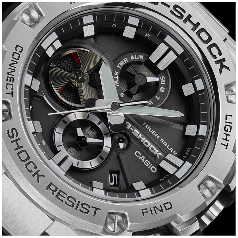 Close-up of CASIO G-SHOCK WATCHES Mod. GST-B100D-1AER showing multifunction dial, stainless steel and resin case, solar movement.