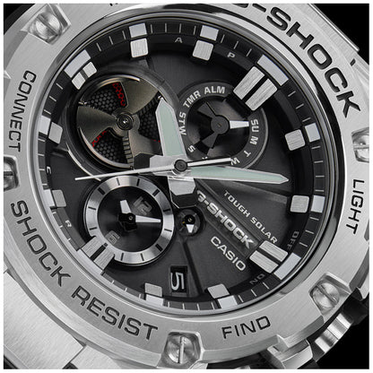 Close-up of CASIO G-SHOCK WATCHES Mod. GST-B100D-1AER showing multifunction dial, stainless steel and resin case, solar movement.
