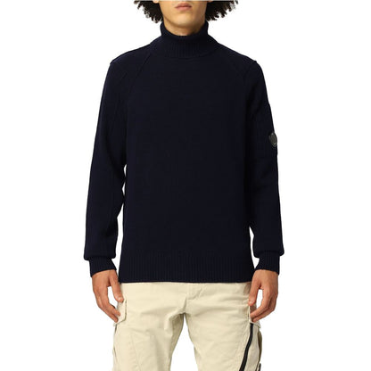 C.P. Company Blue Wool Sweater with ribbed turtleneck and logo plaque, modeled by person in beige pants