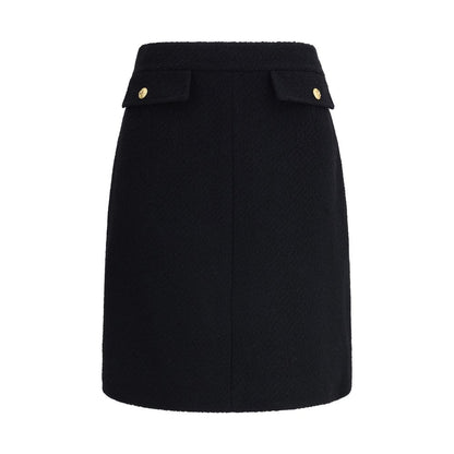 Chloé Black Wool Midi Skirt featuring front flap pockets with gold-tone buttons, crafted from premium bouclé wool for a sleek look.