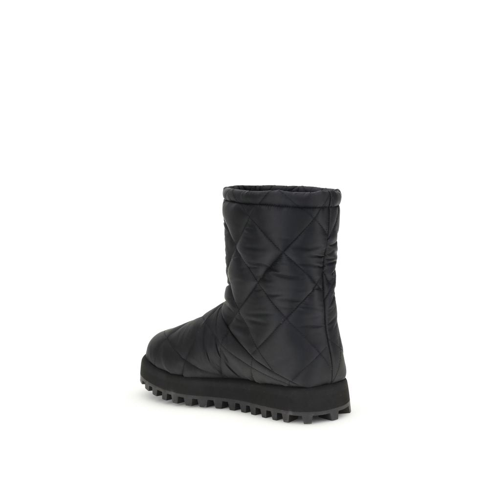 Dolce & Gabbana Black Polyamide Flat Boots with quilted diamond pattern and rubber lug sole, side view.